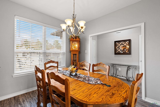 dining room with dark hardwood / wood-style floors and a chandelier