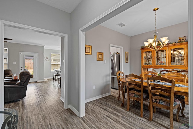 dining room featuring hardwood / wood-style floors and a chandelier