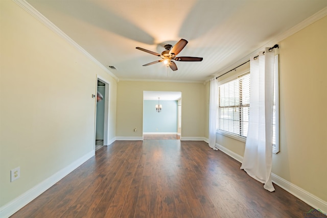 spare room with dark hardwood / wood-style flooring, ceiling fan with notable chandelier, and ornamental molding