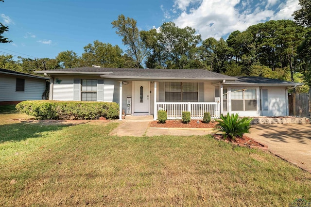 ranch-style house featuring covered porch and a front lawn