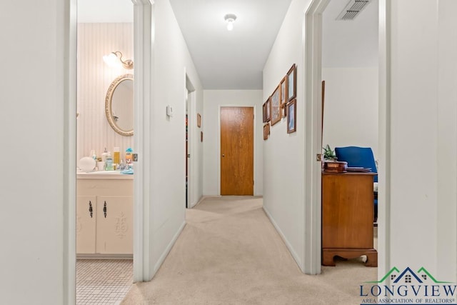 hallway with light colored carpet