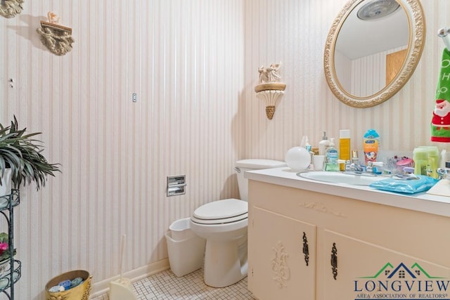 bathroom with vanity, tile patterned flooring, and toilet