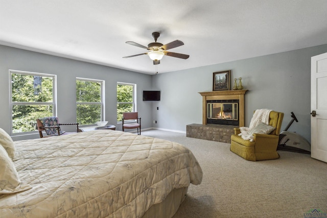 bedroom with carpet flooring, multiple windows, and ceiling fan