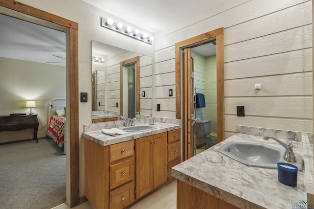 bathroom featuring vanity and wood walls