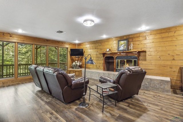 living room with wood walls and dark hardwood / wood-style flooring