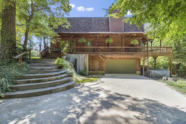 log home featuring a garage and a deck