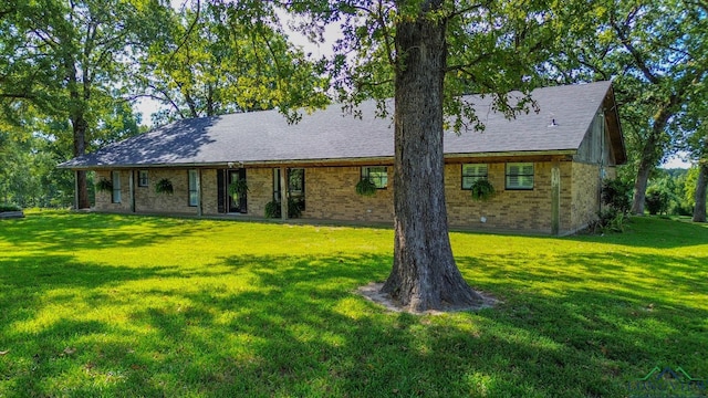 7876 Green Hills Rd, Gilmer, TX 75645 - back of house with brick siding, a yard, and a shingled roof