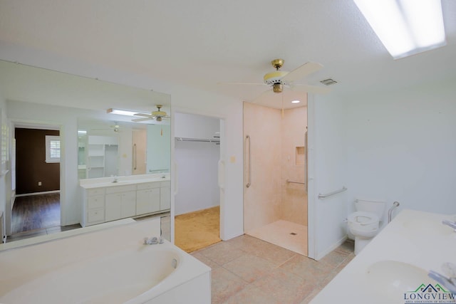 7876 Green Hills Rd, Gilmer, TX 75645 - bathroom featuring ceiling fan, vanity, a bath, toilet, and a walk in shower
