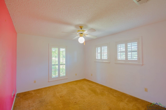 7876 Green Hills Rd, Gilmer, TX 75645 - spare room featuring light colored carpet, a ceiling fan, and a textured ceiling