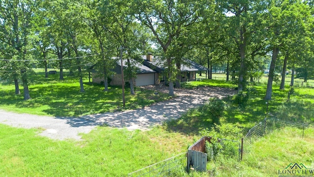 7876 Green Hills Rd, Gilmer, TX 75645 - view of yard with driveway and a garage