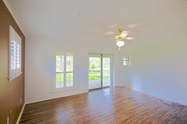 7876 Green Hills Rd, Gilmer, TX 75645 - empty room featuring wood finished floors, plenty of natural light, ceiling fan, and baseboards
