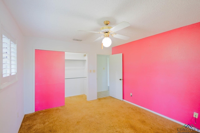 7876 Green Hills Rd, Gilmer, TX 75645 - unfurnished bedroom with carpet flooring, a closet, and a ceiling fan