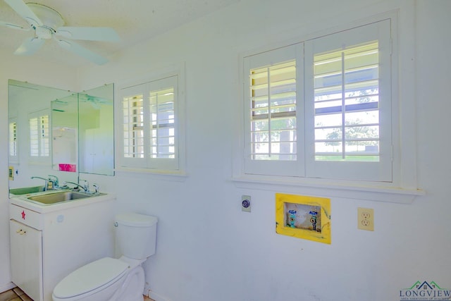 7876 Green Hills Rd, Gilmer, TX 75645 - bathroom with toilet, vanity, and ceiling fan