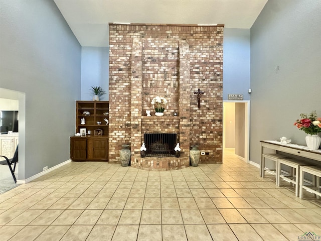 unfurnished living room featuring high vaulted ceiling, light tile patterned flooring, and a fireplace