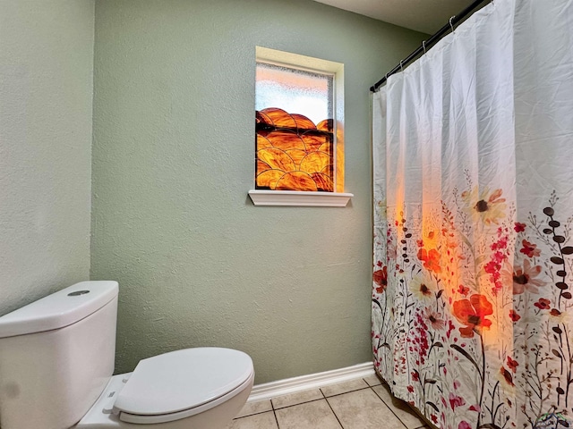 bathroom with tile patterned floors and toilet