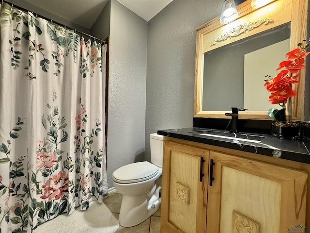 bathroom with toilet, vanity, and curtained shower