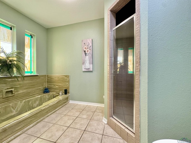 bathroom with separate shower and tub and tile patterned flooring