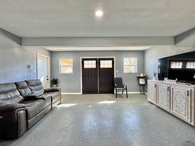 100 Bretta Cir, Longview, TX 75605 - unfurnished living room featuring a raised ceiling, a ceiling fan, and light tile patterned floors