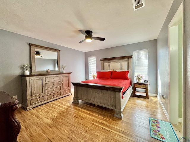 bedroom with ceiling fan and light hardwood / wood-style flooring