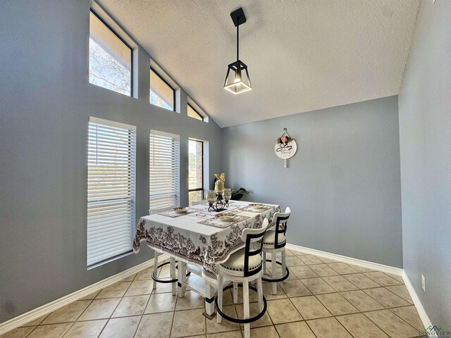 100 Bretta Cir, Longview, TX 75605 - dining space featuring a textured ceiling, vaulted ceiling, light tile patterned floors, and baseboards