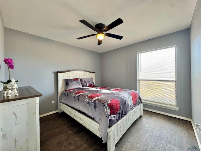 bedroom featuring dark hardwood / wood-style flooring, a textured ceiling, and ceiling fan