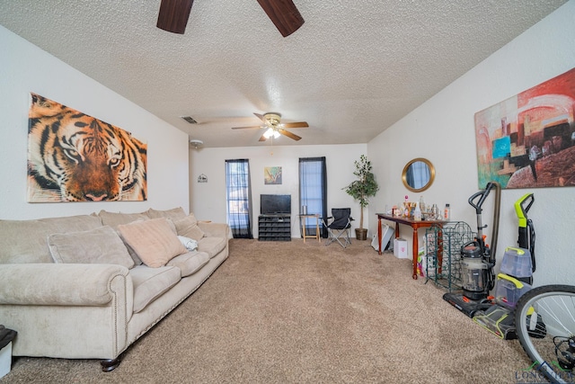 living room with carpet floors, visible vents, a textured ceiling, and a ceiling fan