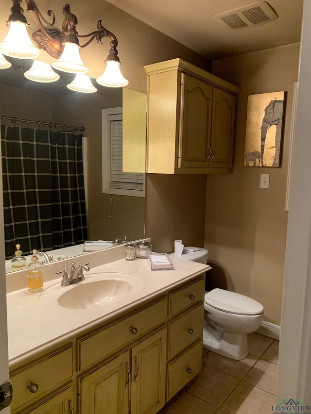 bathroom featuring baseboards, visible vents, toilet, tile patterned floors, and vanity