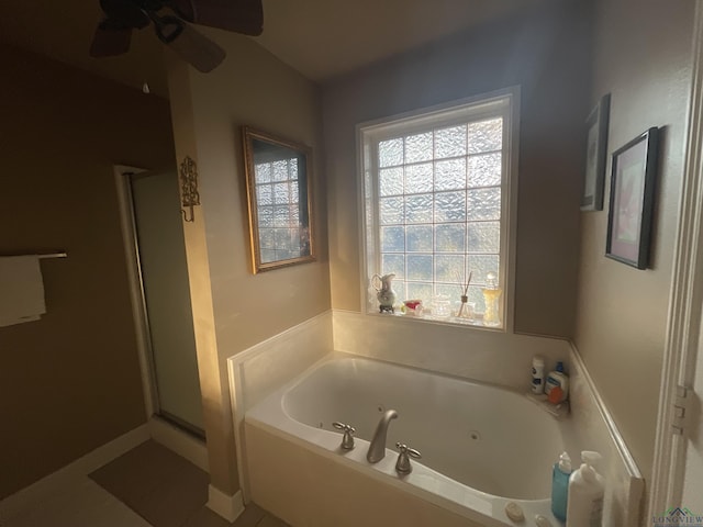 bathroom featuring a stall shower and a tub with jets