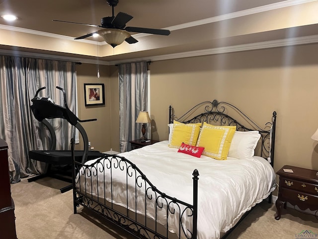 carpeted bedroom with a ceiling fan and crown molding