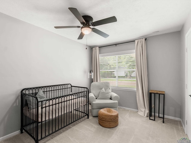 514 N St, Gilmer, TX 75644 - bedroom with carpet flooring, a nursery area, and ceiling fan