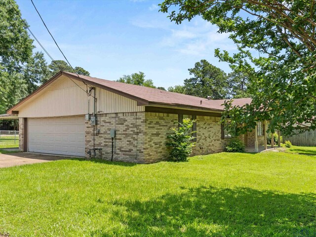 514 N St, Gilmer, TX 75644 - view of side of home featuring brick siding, a garage, and concrete driveway