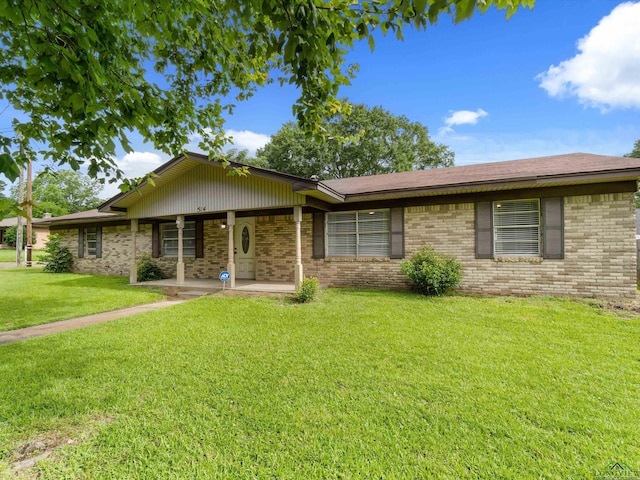 514 N St, Gilmer, TX 75644 - ranch-style house with a front yard and brick siding