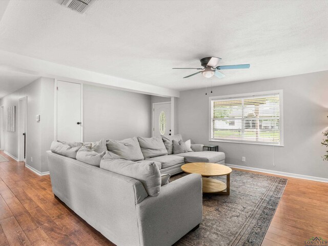 514 N St, Gilmer, TX 75644 - living area with ceiling fan, wood-type flooring, and a textured ceiling