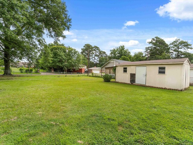 514 N St, Gilmer, TX 75644 - view of yard featuring an outdoor structure