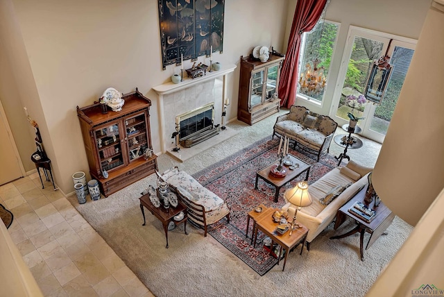 tiled living room featuring a tile fireplace and a towering ceiling