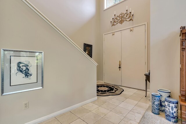 tiled entrance foyer featuring a high ceiling