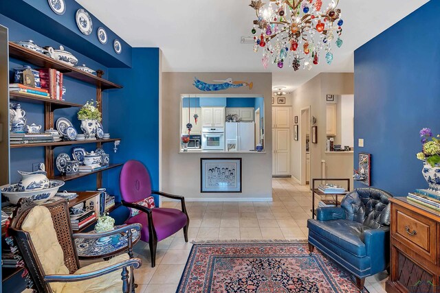 sitting room with a notable chandelier and light tile patterned floors