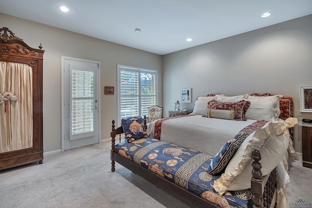 bedroom with access to outside and light colored carpet