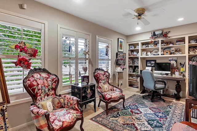 office area with built in shelves and ceiling fan