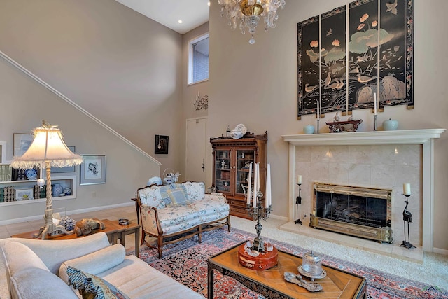 tiled living room with a chandelier and a tiled fireplace