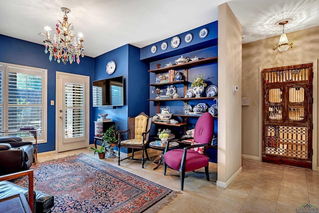 sitting room featuring a notable chandelier and light tile patterned floors