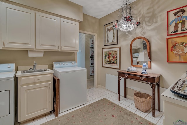 washroom with cabinets, light tile patterned floors, sink, and washing machine and dryer