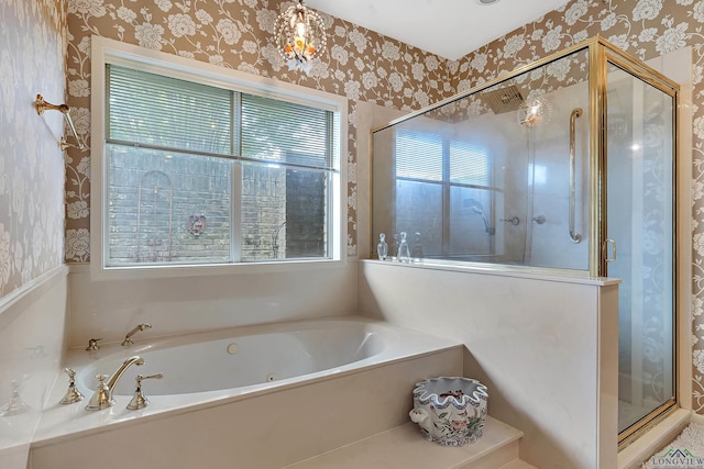 bathroom featuring plenty of natural light and independent shower and bath