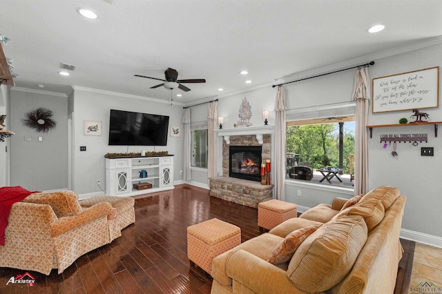 living room with baseboards, ornamental molding, visible vents, ceiling fan, and wood finished floors