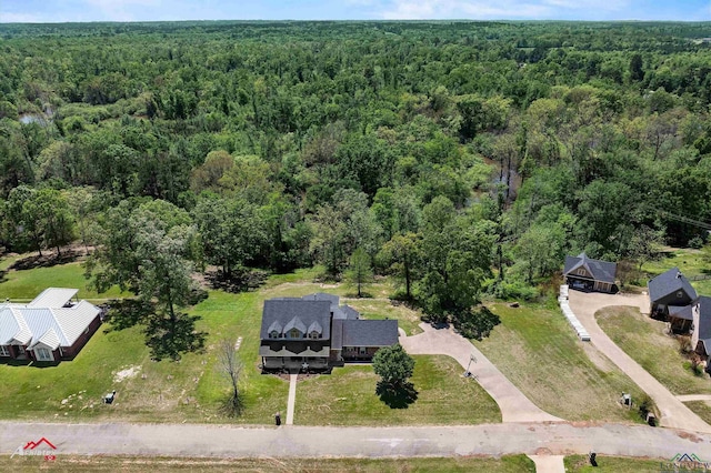 birds eye view of property with a wooded view