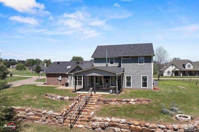 back of house with a patio, a fire pit, and a yard