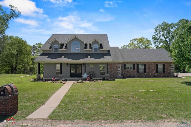 view of front facade featuring a front yard, roof with shingles, stucco siding, and french doors