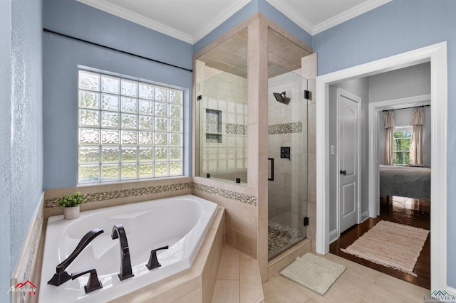 bathroom featuring ornamental molding, a bath, and a shower stall