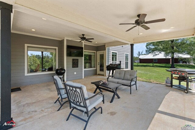 view of patio with grilling area, an outdoor living space, and a ceiling fan