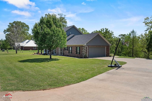 view of front of home with a front yard, an attached garage, brick siding, and driveway